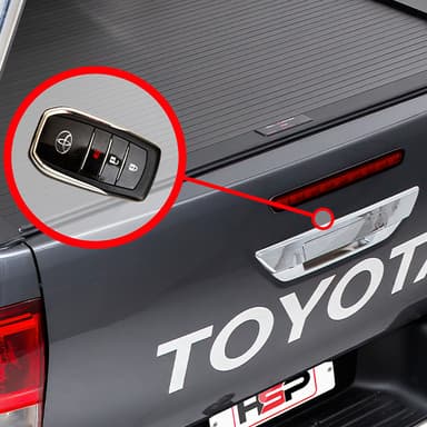Close up of HSP Tail Lock installed on Toyota Hilux tailgate with closed HSP Roller Cover, alternate angle showing lock position