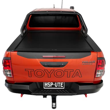 Rear view of orange Toyota Hilux Rugged X with HSP Roll Top and HSP Roller Cover closed