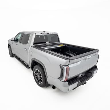 Rear three quarter view of silver Toyota Tundra with open HSP Roller Cover fitted over tub