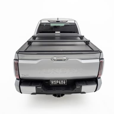 HSP Load Bars fitted over closed HSP Roller Cover on grey Toyota Tundra, rear view showing rack compatibility and secure tub coverage