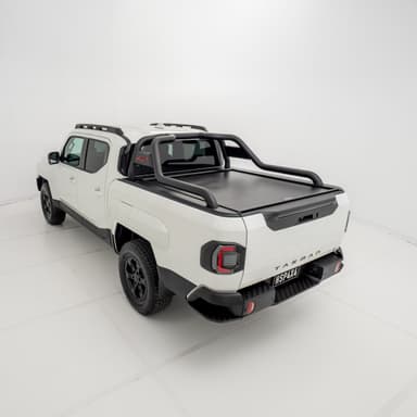 Angled 3/4 rear view of a white Kia Tasman fitted with an HSP Roll R electric roller cover in the closed position with black sports bars mounted.