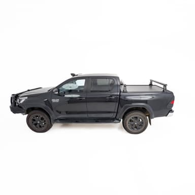 HSP Load Rack JNR fitted to black Toyota Hilux dual cab, side profile view showing compact rack over closed HSP Roller Cover