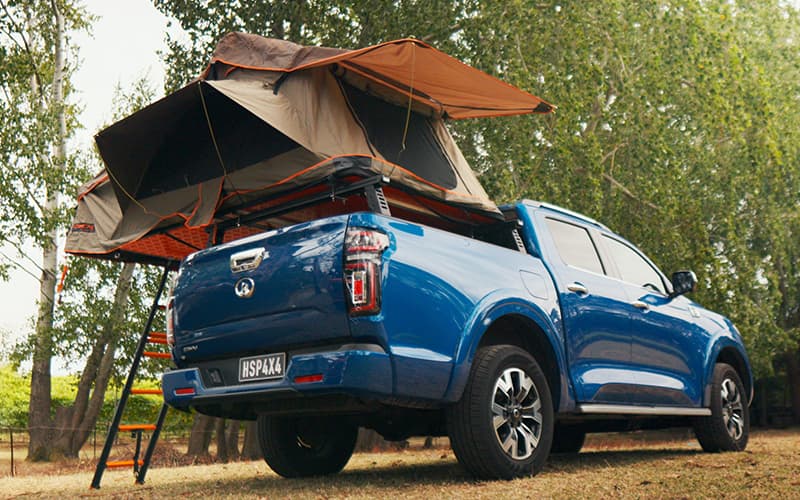 Ute equipped with a tub rack fitted with a rooftop tent, perfect for off-road and overlanding use